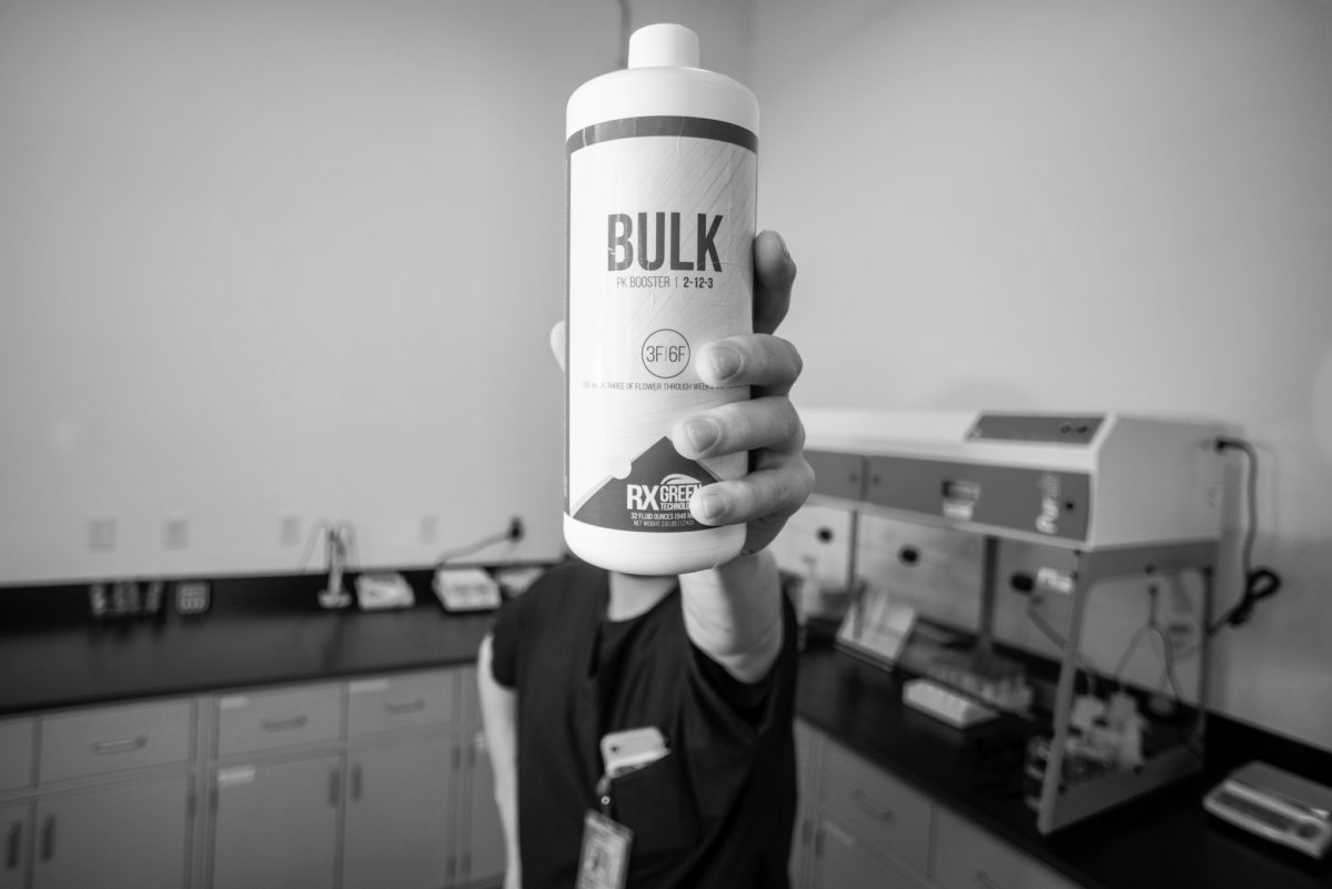 Person Holding BULK PK Booster Additive